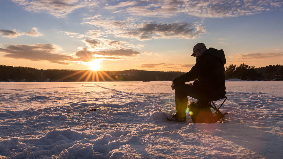 Staying warm while ice fishing on a bucket